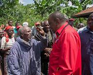 File photo- President Uhuru in a light moment with an elderly man who is under the inua jamii programme
