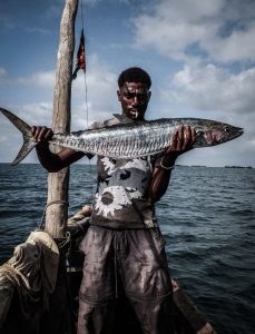 A good catch. A Kenyan fisher man displays a huge fish. Kenyan fisher men have been facing competition from illegal fisher men