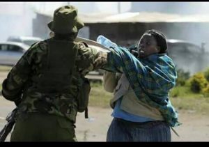 An udated photograph of a police officer assaulting a helpless woman