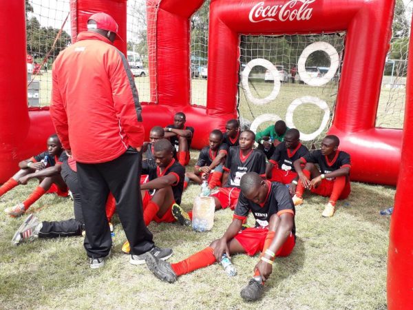 Kenya's Under 16 Boys' Soccer team receive tips from their tacticians at the half time break during their semi final clash against Zambia today. Kenya won 1-0