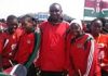 Kwale Girls' soccer team coach, Mukasa Amboko, poses with his players. The girls have won this year's SOYA awards