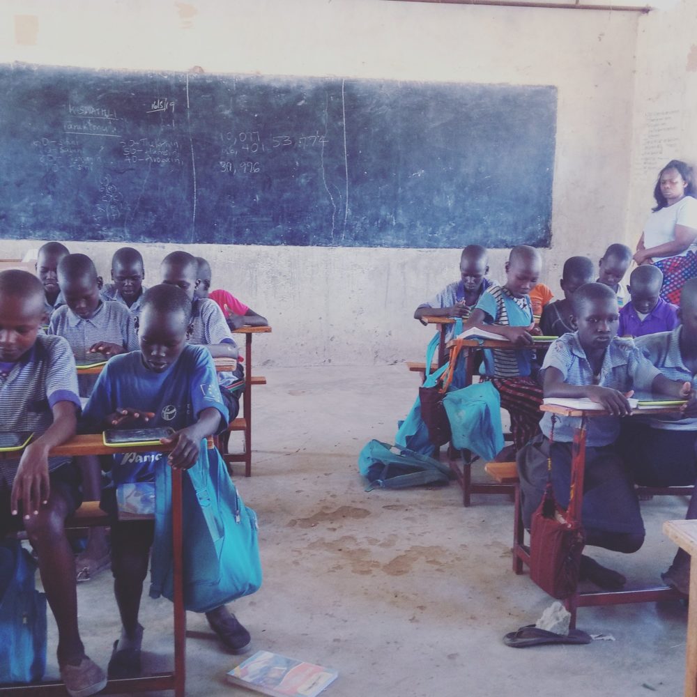 Photo- Grade three children using digital devices for a math lesson at Kabulokorr primary school in Loima Turkana County.