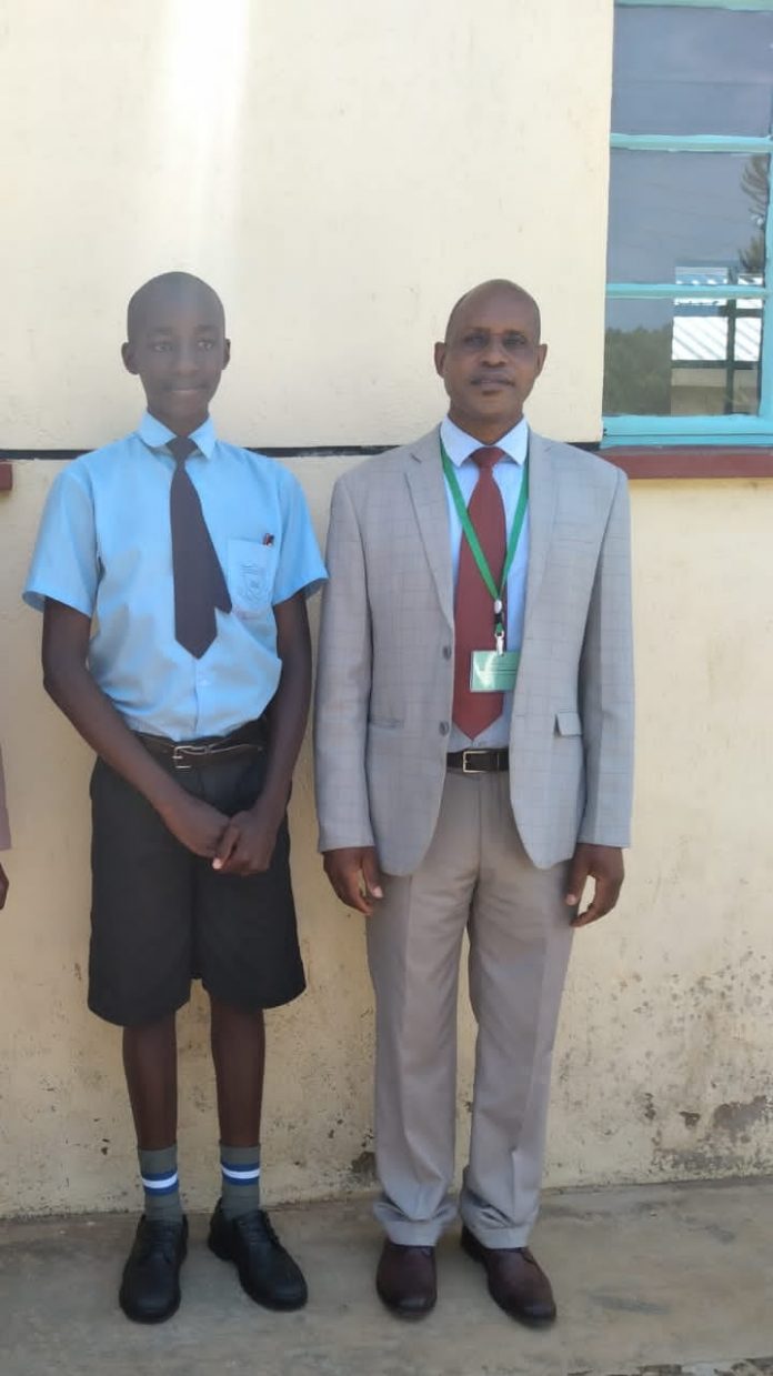 Head teacher of Eronge Adventist Boarding School in Nyamira County with Griffins Amwoma who scored 427 marks in KCPE 2020 Exam
